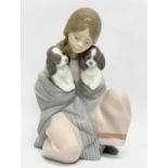 A Lladro figurine ‘Snuggle Up’ 16.5cm.