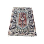 A vintage Middle Eastern hand knotted rug. 124x198cm