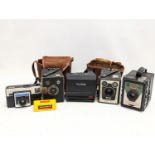 A quantity of vintage cameras and cases, including Kodak, Polaroid, etc.