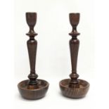 A pair of early 20th century oak candlesticks. 27.5cm