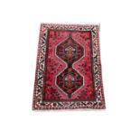 A vintage Middle Eastern hand knotted rug. 99x147cm