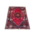 A large vintage Middle Eastern hand knotted rug. 167x268cm