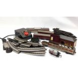 A quantity of vintage Tri-ang train carriages with tracks and train speed controller.