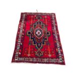 A large vintage Middle Eastern hand knotted rug. 162x267cm