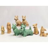 8 Sylvac pottery dog figures. Largest measures 16x12cm