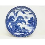 A large 19th century Chinese blue and white pottery charger. 37cm