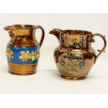 2 early to mid 19th century hand painted lustre pottery jugs. Largest 19x15cm