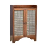 An early 20th century mahogany specimens cabinet with double lead glass panel doors. Circa 1910-