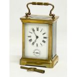 A late 19th century brass carriage clock with key