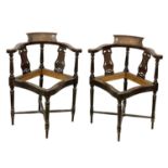 A pair of Edwardian inlaid mahogany corner chairs.