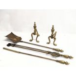 A pair of early 20th century brass firedogs, with early 20th century brass fire tools.