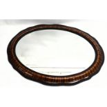 A large early 20th century bevelled oval mirror. 91x65cm