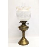 An early 20th century brass double burner oil lamp with glass shade and funnel. 55cm