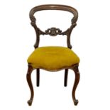 A Victorian rosewood ballon back side chair on cabriole legs.