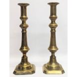 A pair of Victorian brass candlesticks. 31cm