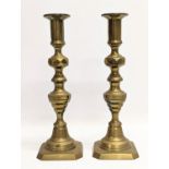 A pair of Victorian brass candlesticks. 27cm