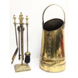 A vintage brass coal scuttle with brass companion set.