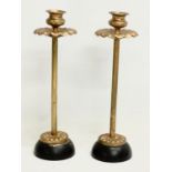 A pair of late 19th century gilt brass candlesticks. 25cm