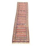 A late 19th/early 20th century Middle Eastern hand knotted runner rug. 291x70cm