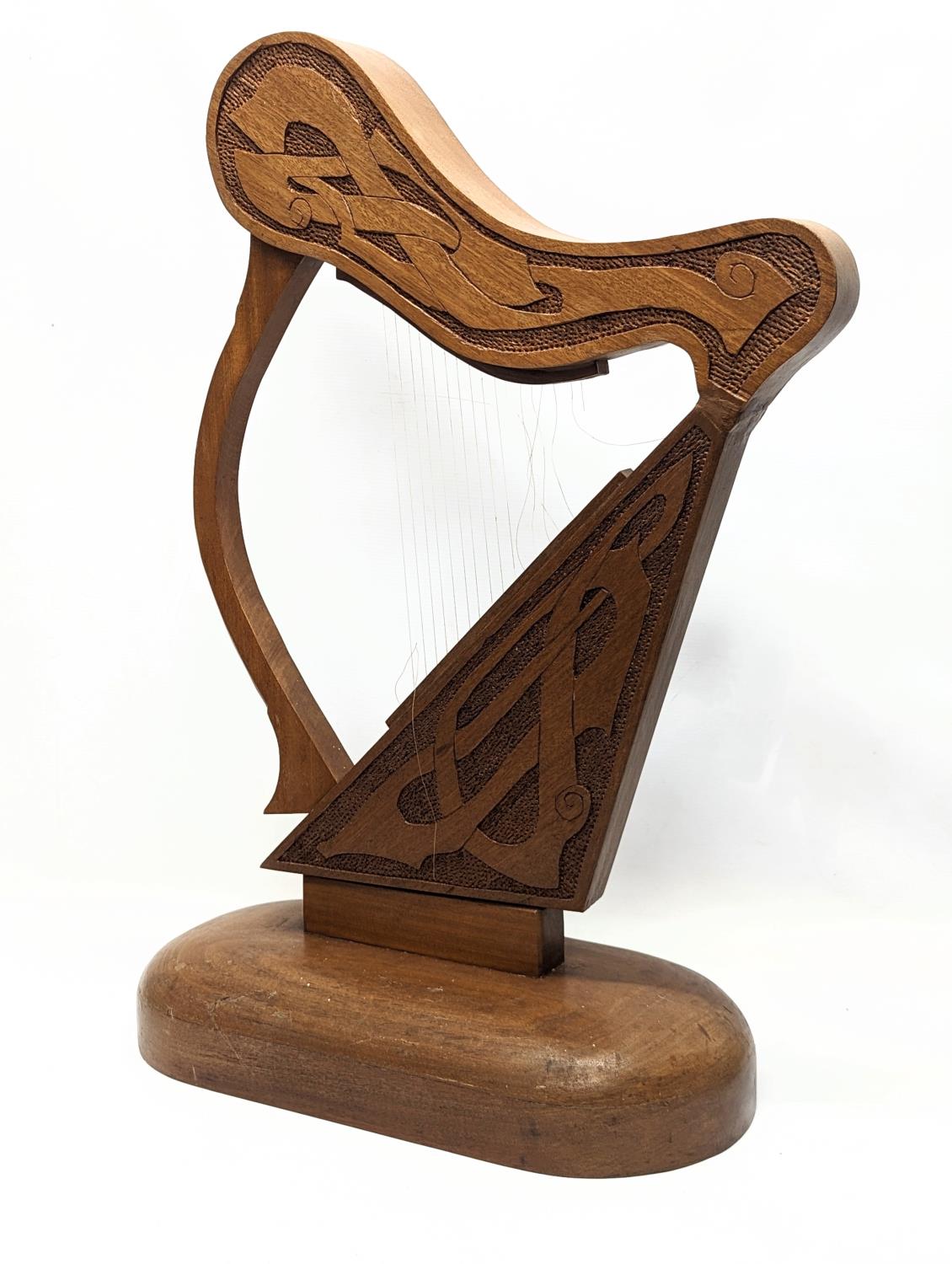 A large carved walnut ornamental harp with Celtic engraving. 75.5x48cm - Image 2 of 3