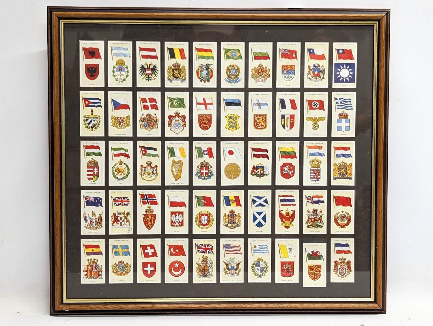 A framed collection of vintage John Players & Sons cigarette cards, National Flags and Arms. 51.