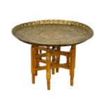 A vintage Middle Eastern folding table with a brass top. 54x37cm