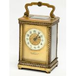 A 19th century ornate brass carriage clock by Walter Wyatt. With key. 8x6x14cm including handle.