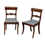 A piar of George IV mahogany bar back chairs on sabre legs.