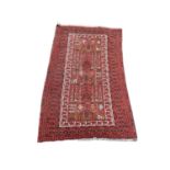 A vintage Middle Eastern hand knotted rug. 99x169cm