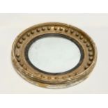 A large Regency period gilt framed convex mirror. Circa 1810-1820. 59cm.