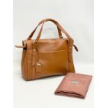 A ladies leather handbag by Radley with cover.