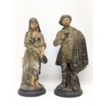 A pair of early 20th century pottery figures. 34.5cm