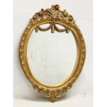 A large ornate gilt framed mirror. 79x115cm