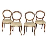 A set of 4 Victorian Walnut balloon back chairs on cabriole legs.