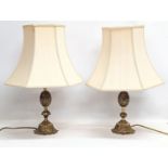 A pair of ornate brass table lamps. 56cm