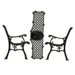 A pair of cast iron garden bench ends and back