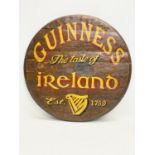 A Guinness painted barrel top. 53cm