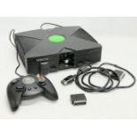 An XBOX console with controller and leads.