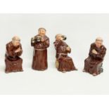 A set of 4 vintage pottery gambling monks by Bretby. 21cm