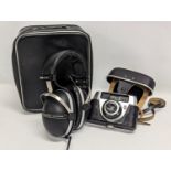 A pair of vintage Pioneer SE-305 Headphones in case with a Regula camera