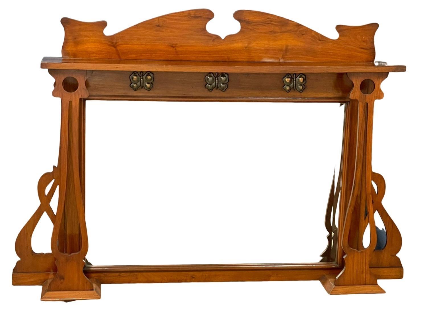 A late 19th century Art Nouveau walnut over-mantle mirror, with copper butterfly decoration.