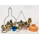 A quantity of 19th and early 20th century oil lamps, shades oil lamp parts.