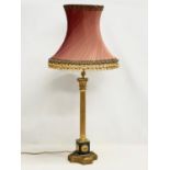 A tall good quality gilt brass table lamp with Corinthian style pillar. Base measures 18x63cm.