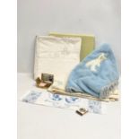 A sundry lot. Including a pair of wooden clogs, a vintage musical compact, linen, vintage throws and