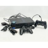 A PlayStation 2 (PS2) with 2 controllers, memory card and leads.