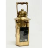 A brass ships binnacle lamp. Stamped L.S Co LTD. 10x26cm including handle.