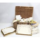 A quantity of good quality linen with wicker basket.