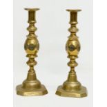 A pair of large Victorian brass Bullseye Good Luck candlesticks. 29cm