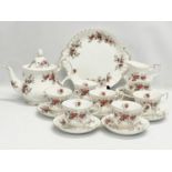 A 21 piece Royal Albert Lavender Rose tea set. Teapot measures 25x20cm