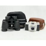 A pair of Tasco binoculars and a vintage camera.
